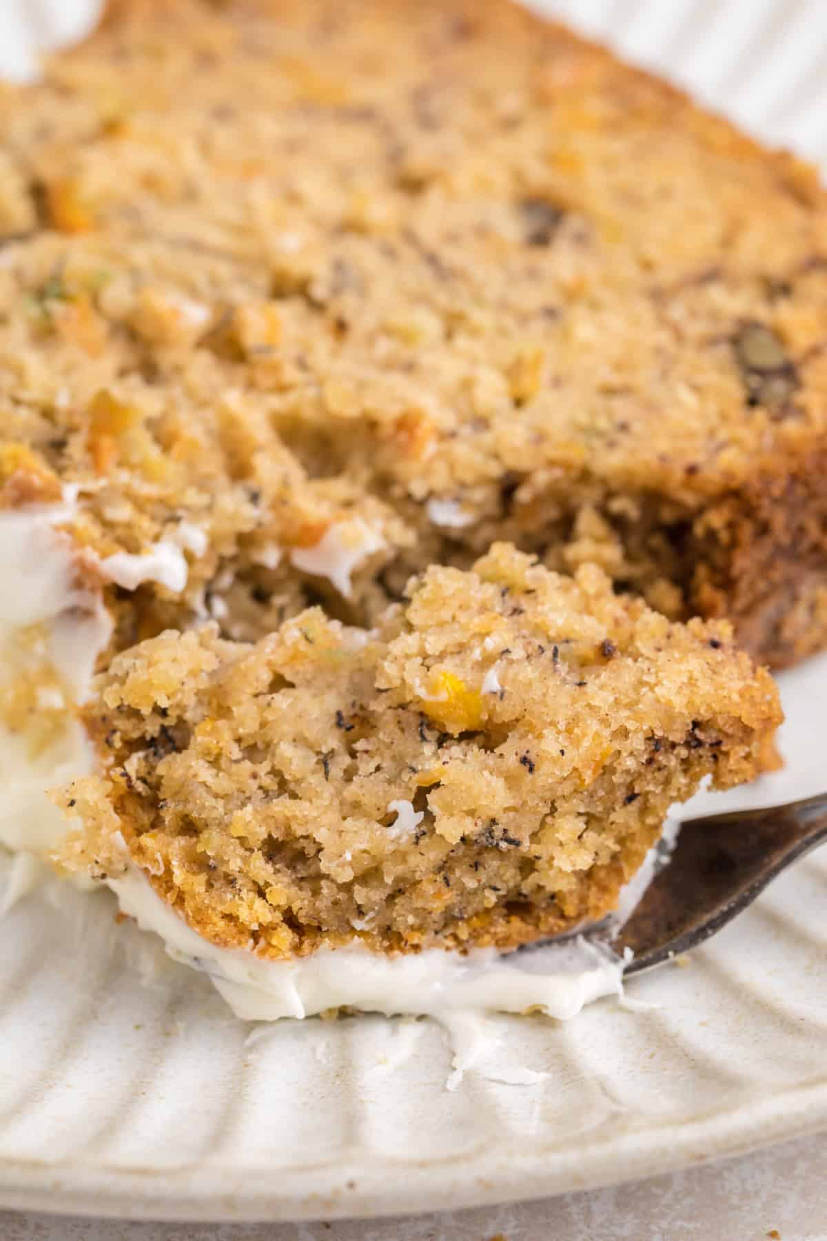 a fork taking a piece of Carrot Cake Banana Bread.