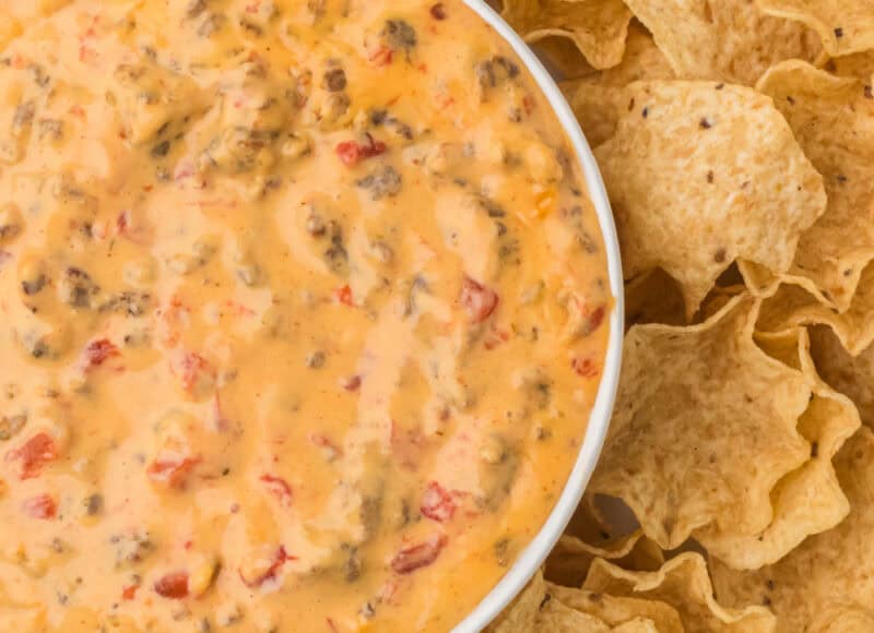 Rotel Cheese Dip in a white bowl with tortilla chips.