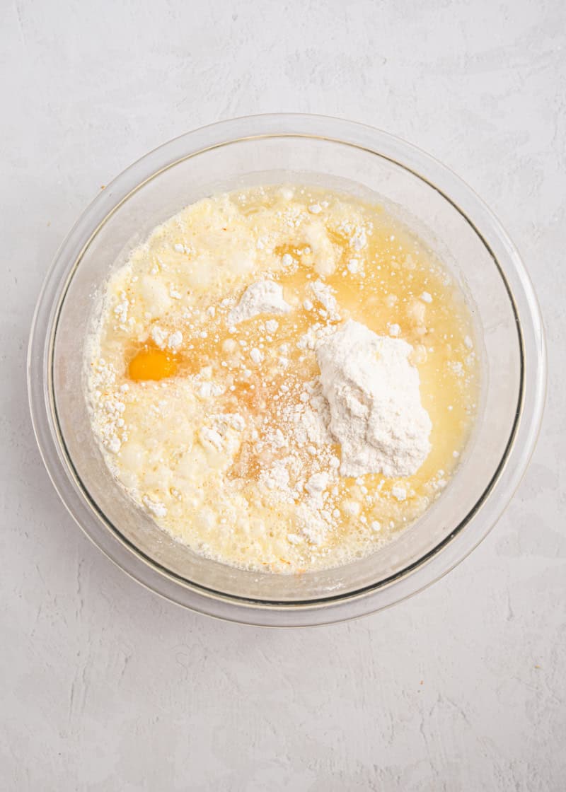Cake mix, water and eggs in a glass bowl.