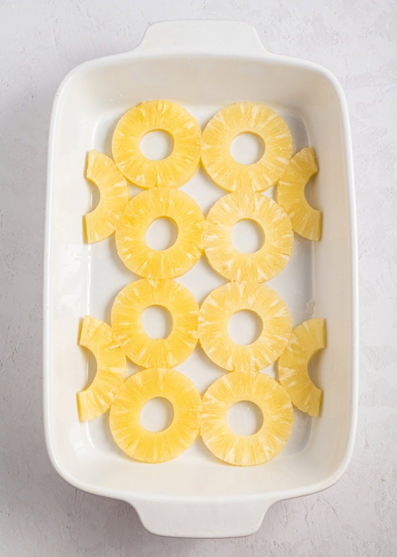 Pineapple slices in a baking dish.