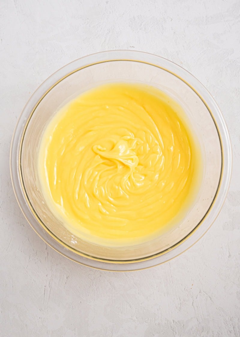 A bowl of pudding for pineapple poke cake.