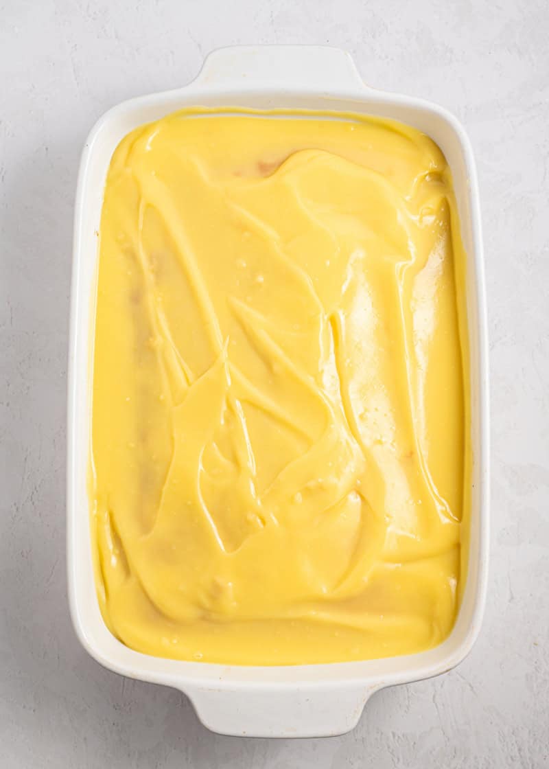 Pudding covering a cooked cake.