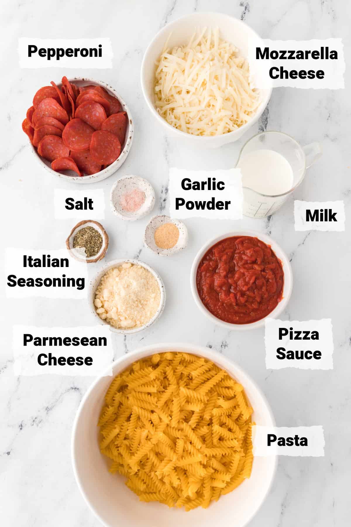 Ingredients on a table to make pizza pasta casserole.