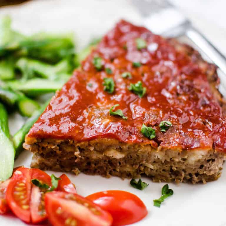 A slice of meatloaf made with stove top stuffing on a white plate.