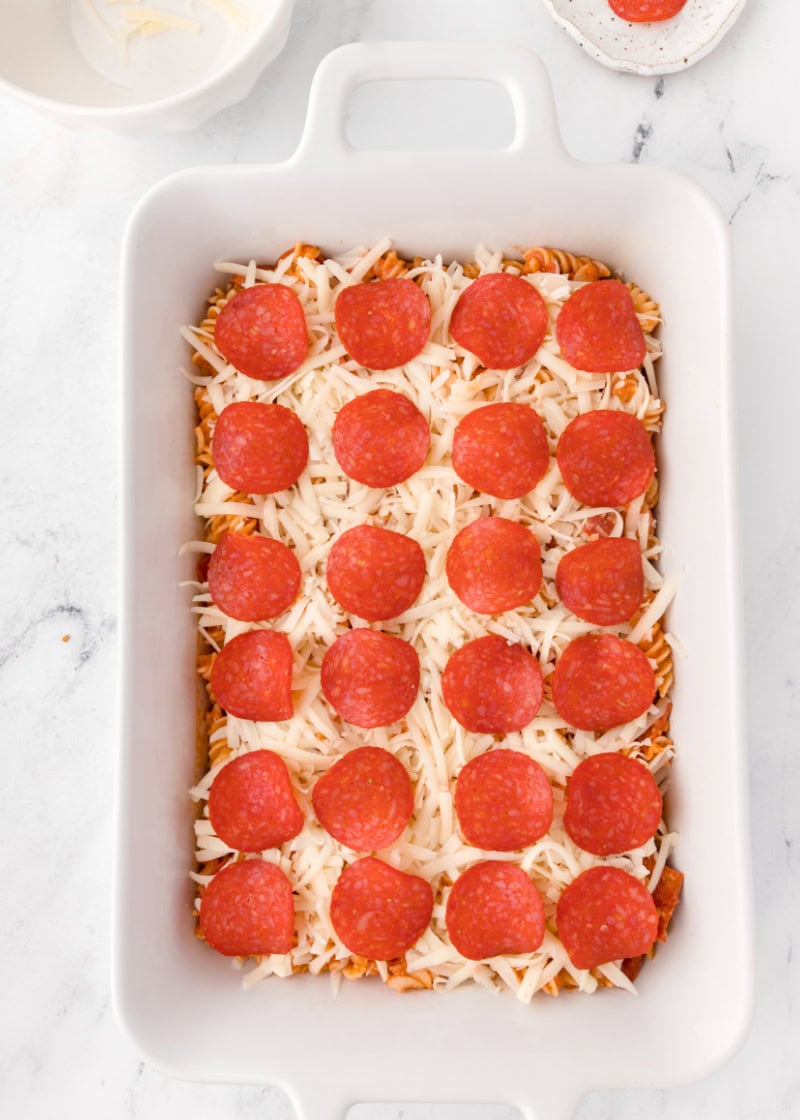 unbaked pizza casserole in a baking dish.