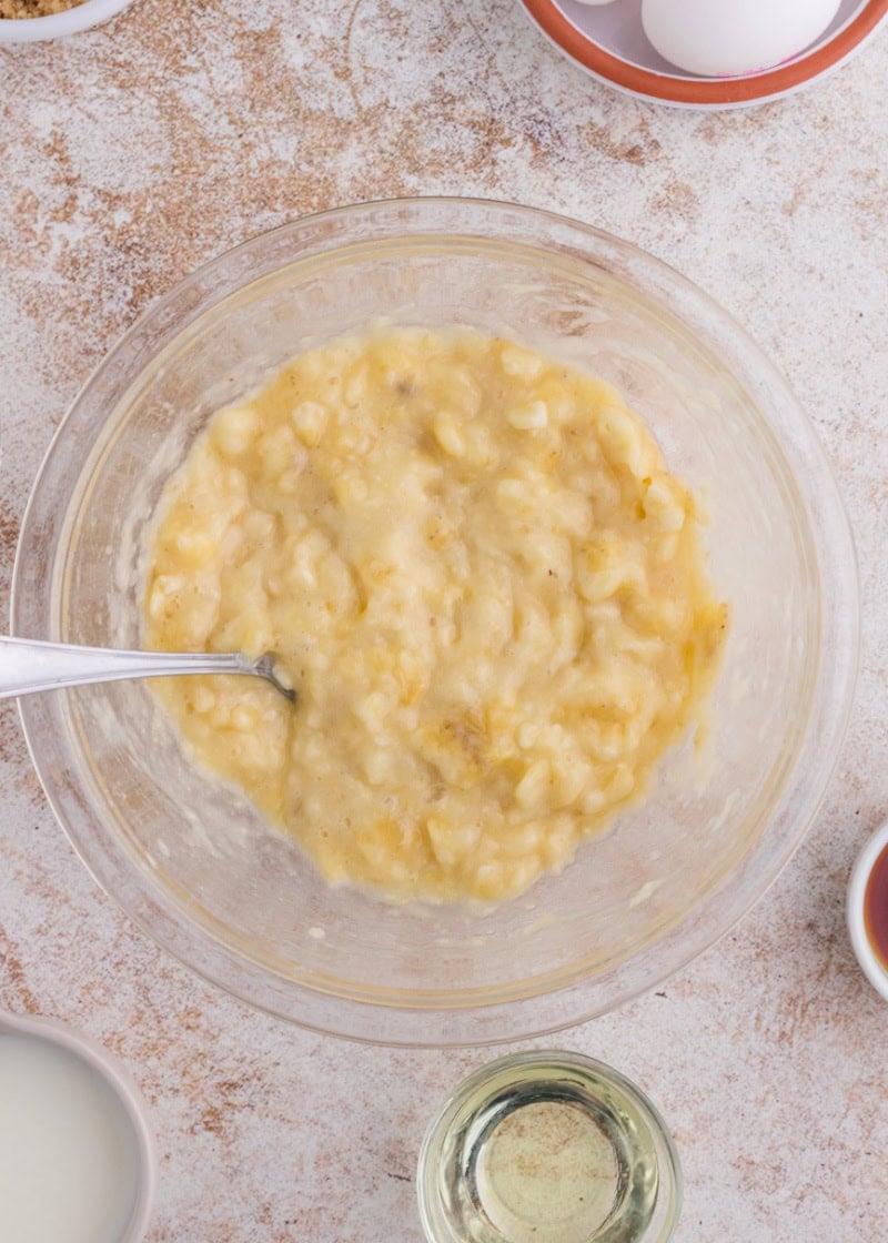 mashed bananas in a glass bowl, to make bisquick banana bread.