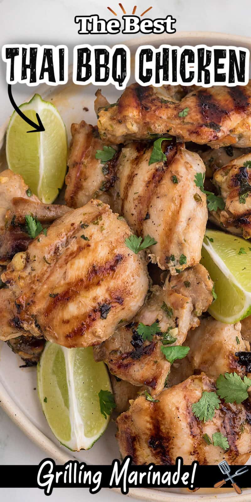 Thai BBQ Chicken piled on a plate with lime wedges.