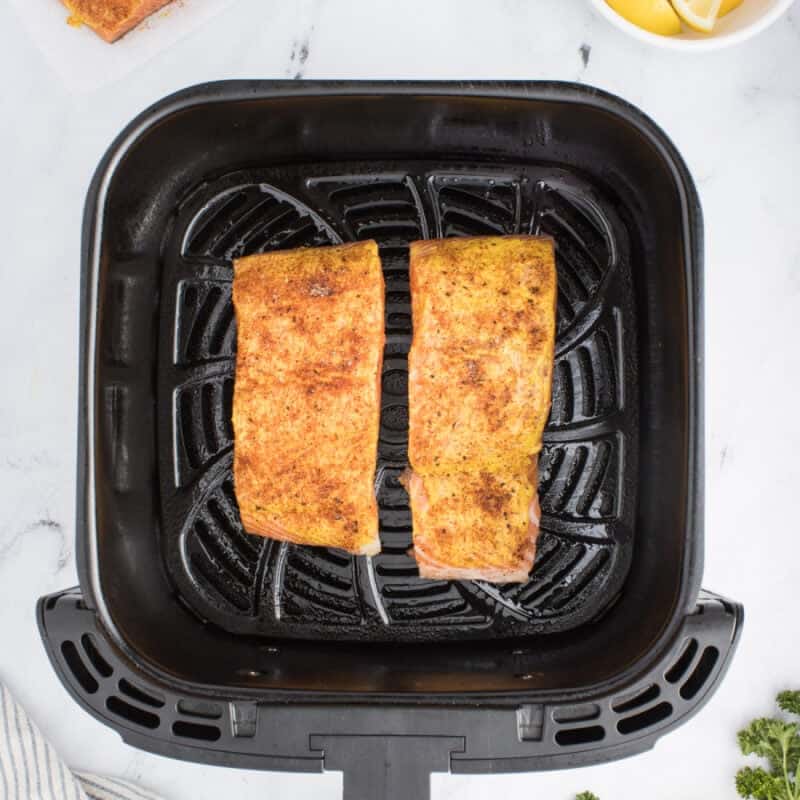 Salmon fillets in an air fryer.