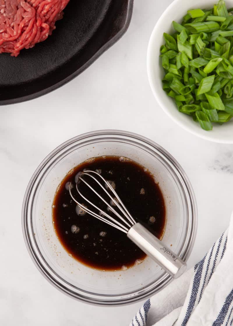 a bowl with soy sauce and ginger.
