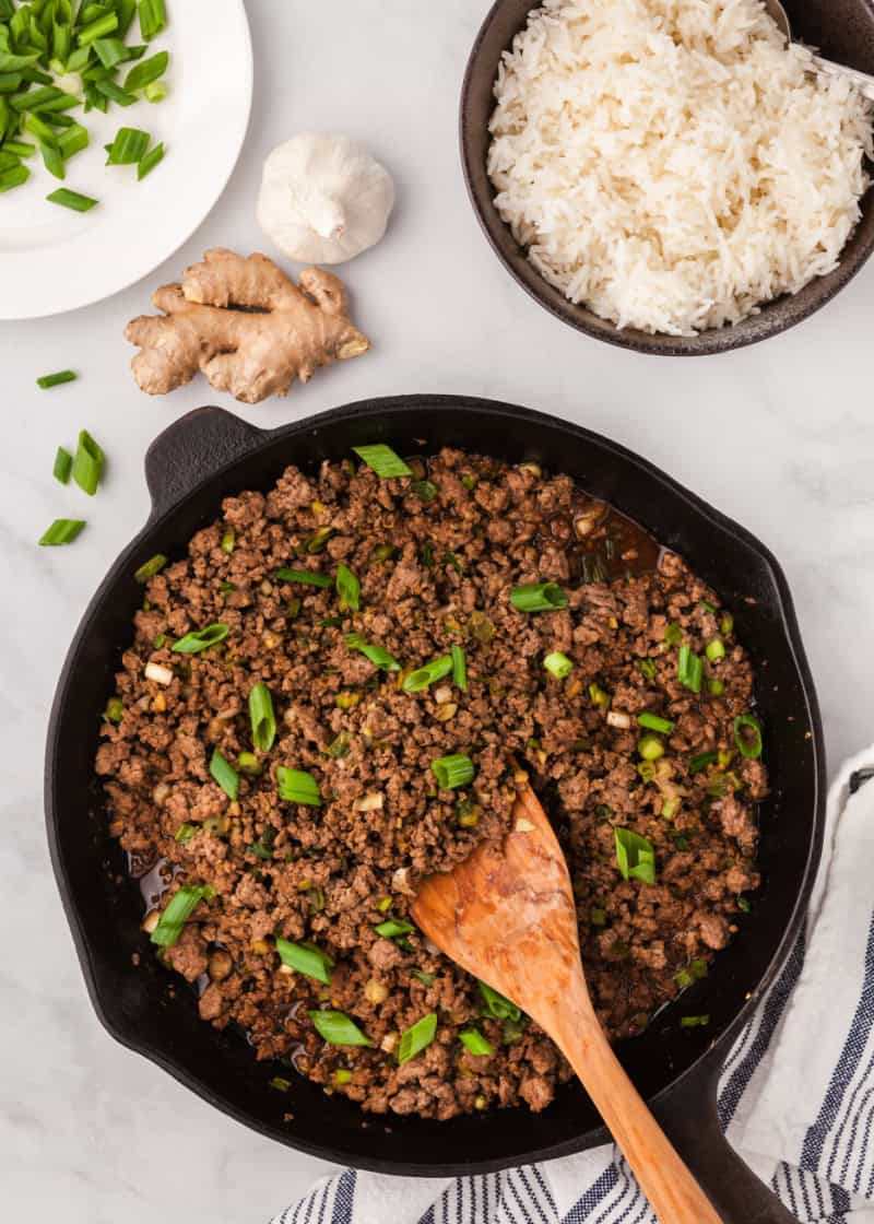 Korean ground beef in a skillet with a side of cooked rice.