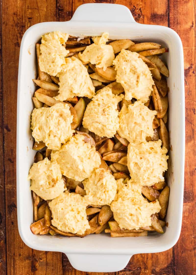 Unbaked Apple Cobbler made with Cake Mix in a white baking pan on a table.