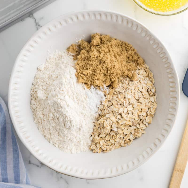 Brown sugar, oats and flour in a bowl.