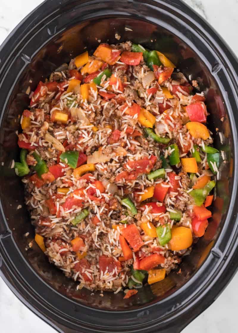Slow Cooker Stuffed Pepper Casserole in a black crockpot dish.