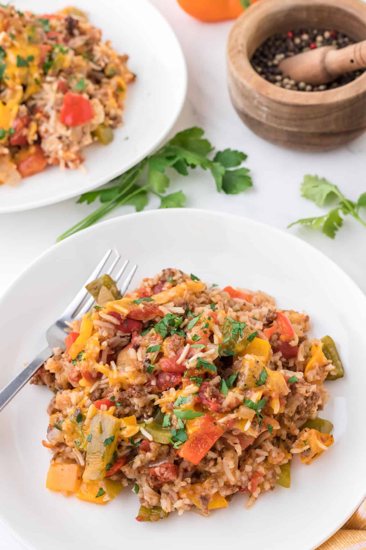 Slow Cooker Stuffed Pepper Casserole on a white plate with a fork.