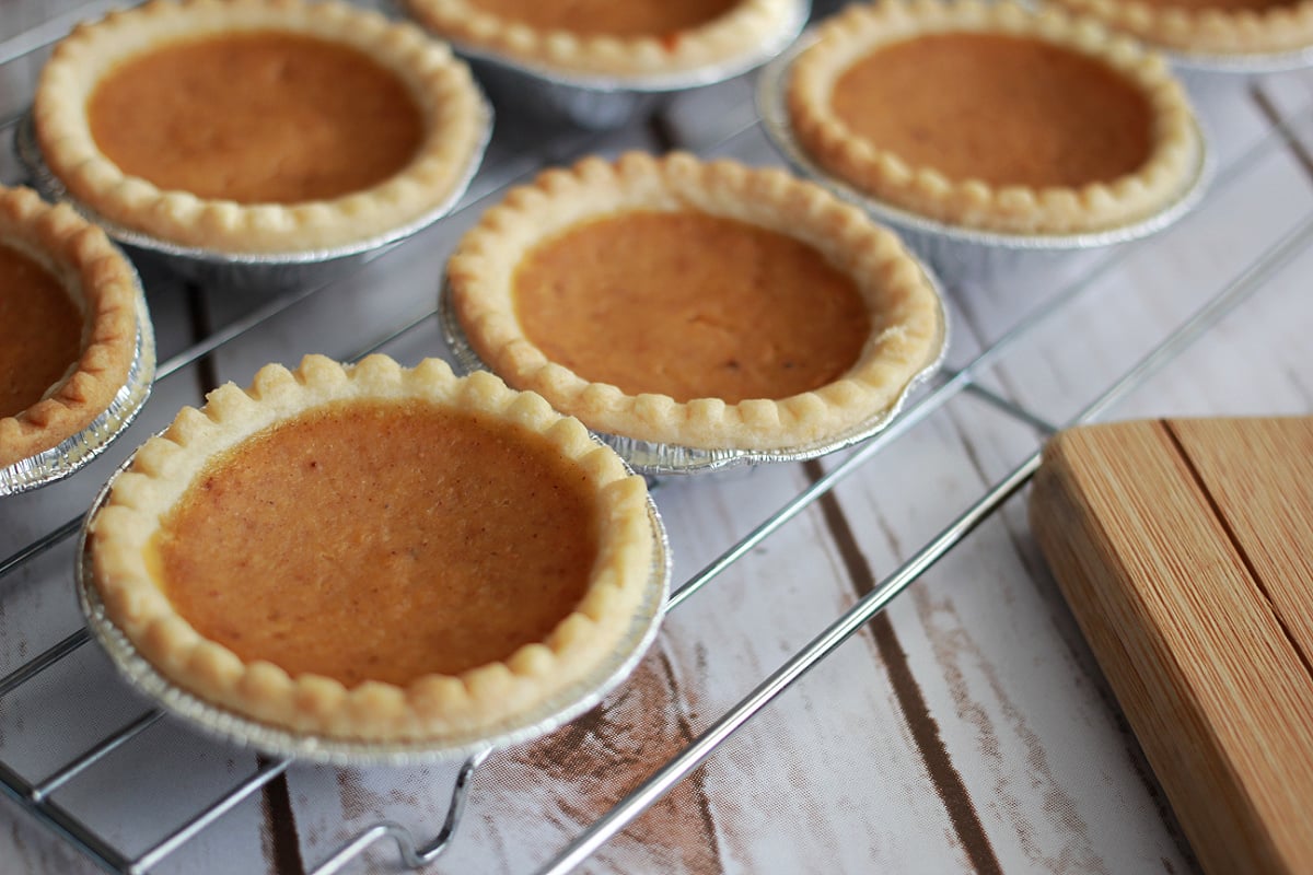 Individual Mini Pumpkin Pies with whipped cream on top.